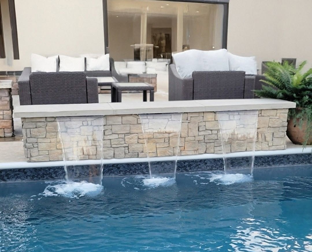 Rock waterfall water feature on a custom Coconut Grove pool