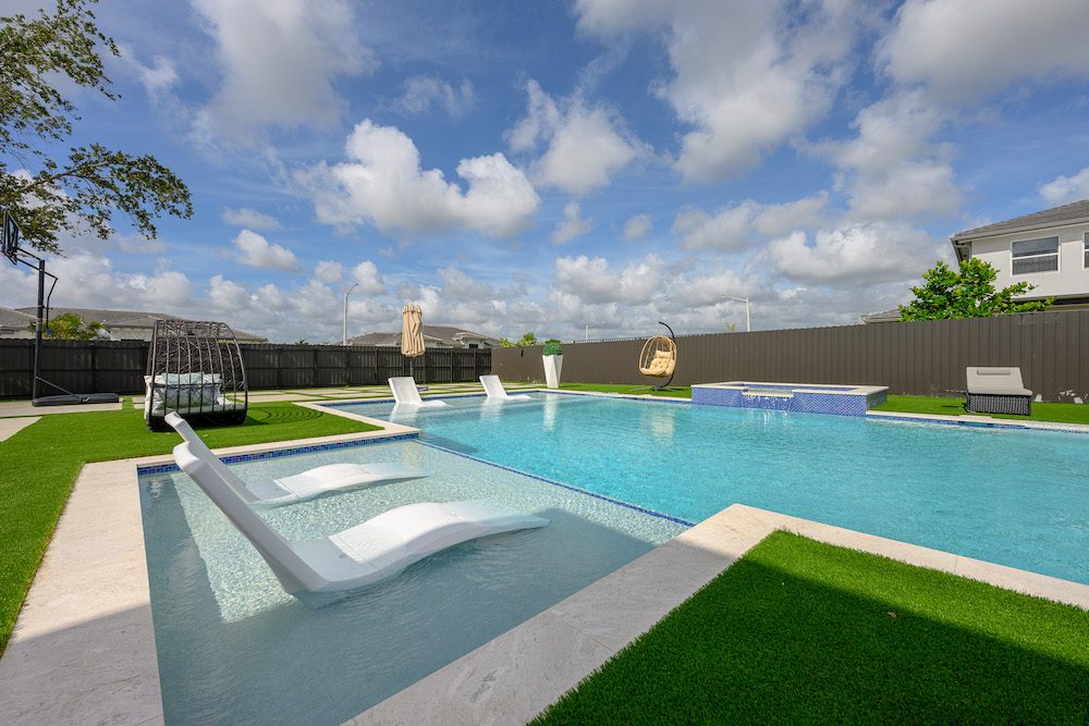 Bright, clear turquoise pool water showing the finish surface on a Miami backyard pool