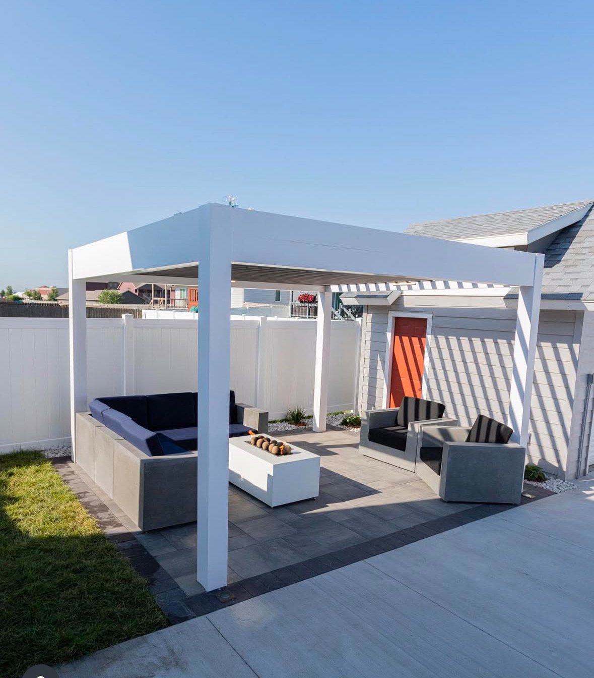 Freestanding pergola over a fire-table lounge area built by Dream Pools FL