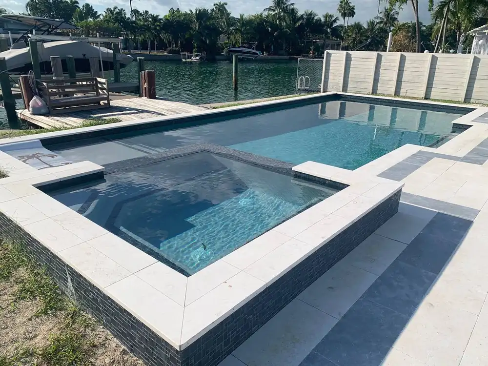 New construction swimming pool with custom decking in Miami-Dade
