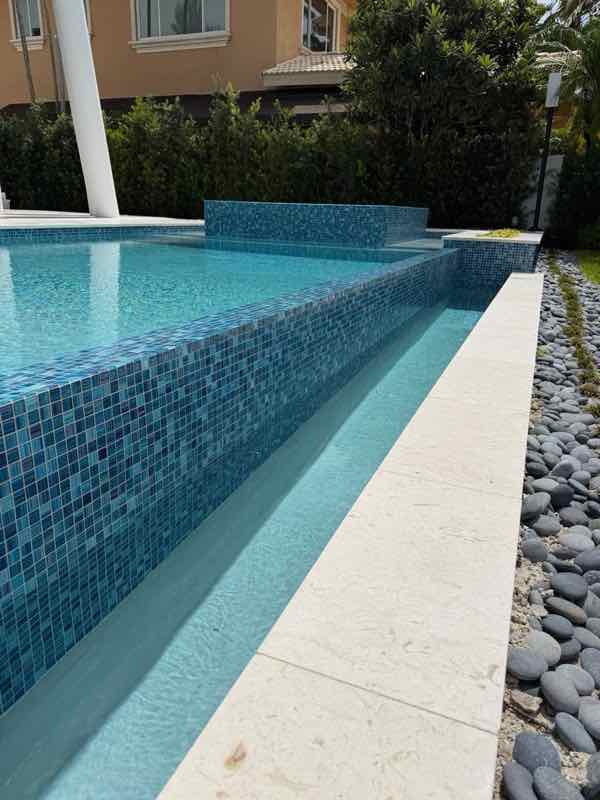 Custom inground pool with glass tile waterline built by Dream Pools FL in Miami-Dade County