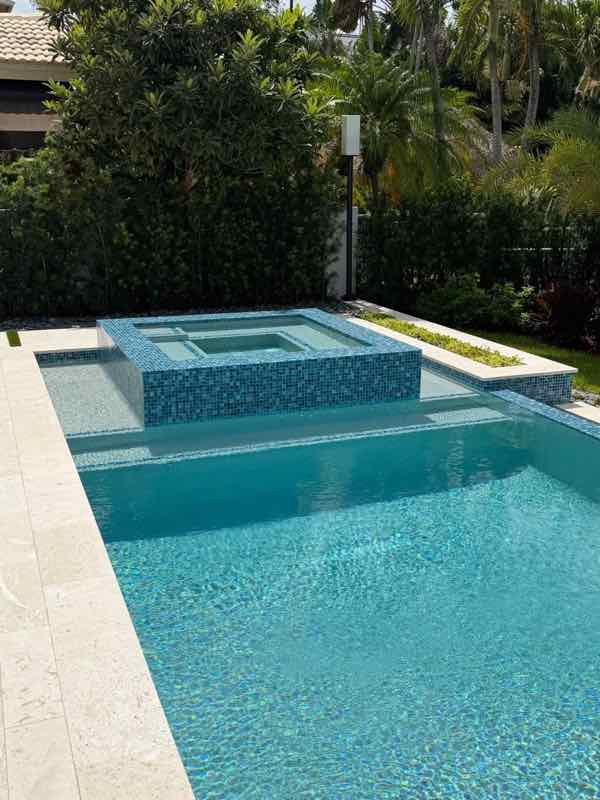 Custom inground pool with raised tiled spa built by Dream Pools FL in Miami-Dade County