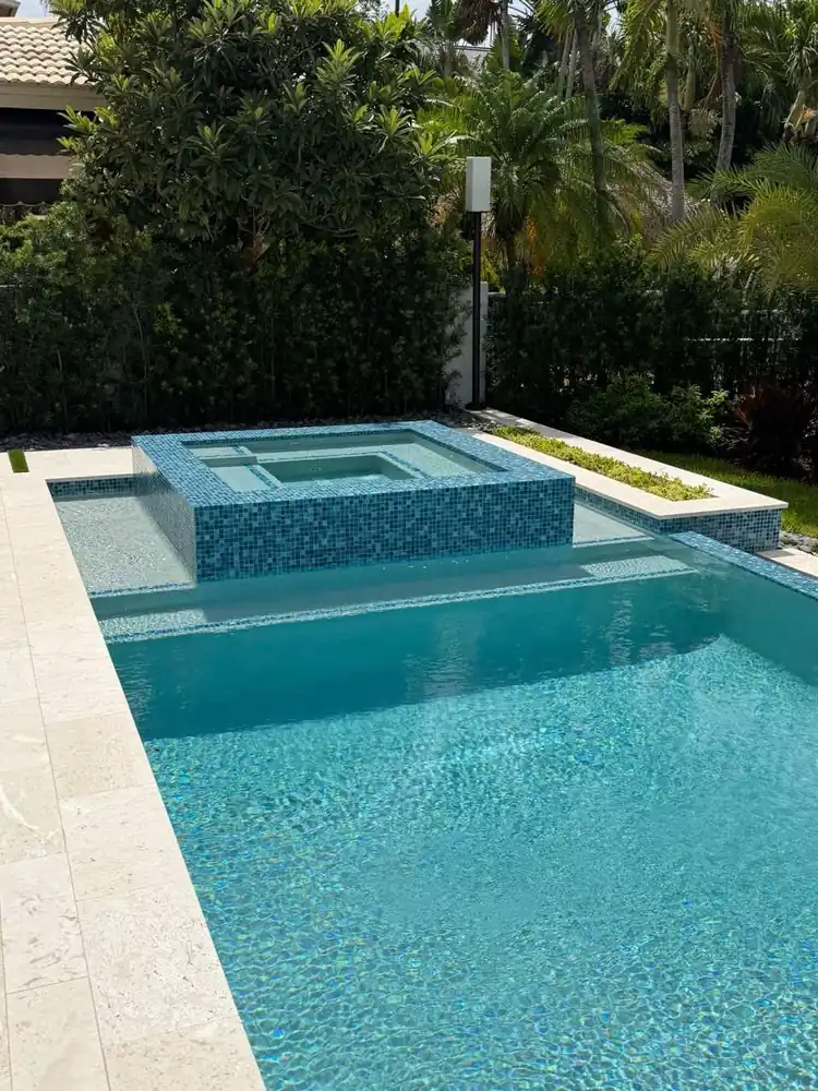 Custom inground pool with raised tiled spa built by Dream Pools FL in Miami-Dade County