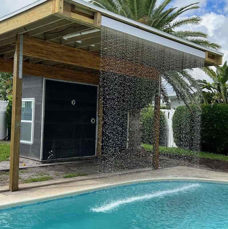 Rain curtain water feature on a custom pool built by Dream Pools FL in Miami-Dade County