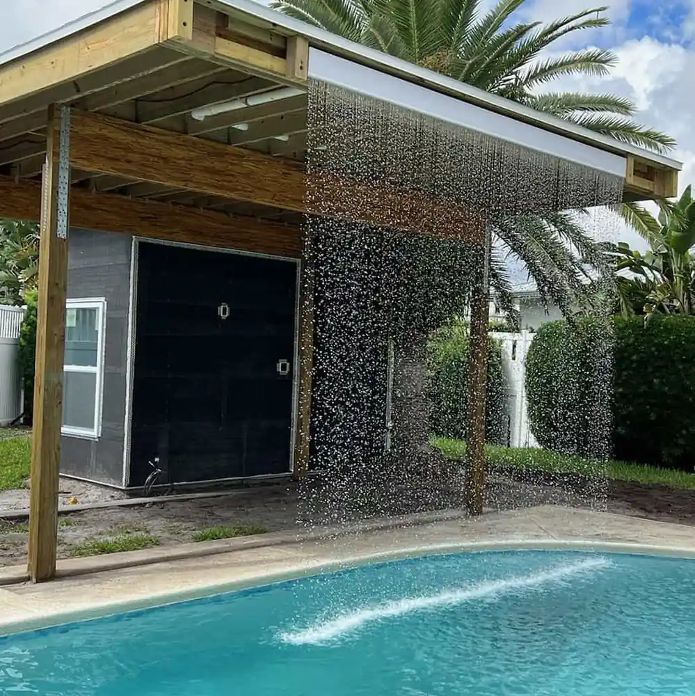 Rain curtain water feature on a custom pool built by Dream Pools FL in Miami-Dade County