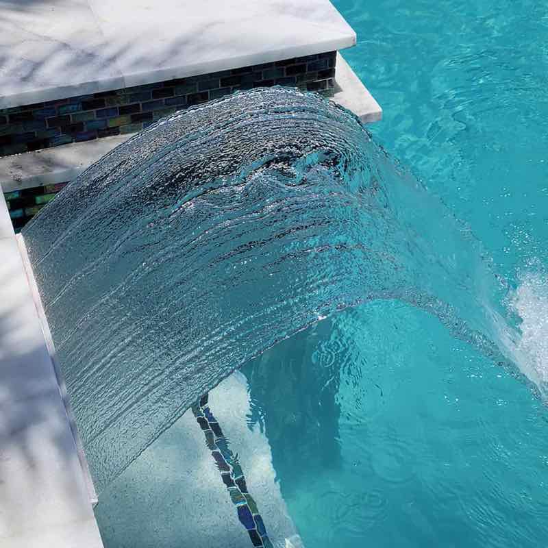 Sheer descent water feature on a custom Miami pool