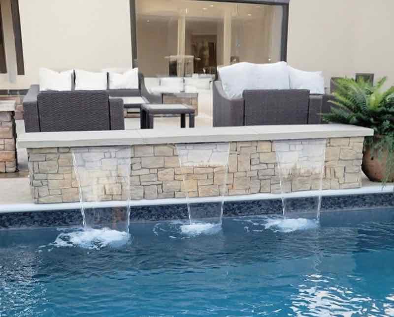 Sheet cascade waterfall feature on a custom pool in Miami