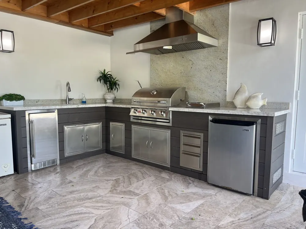 Outdoor kitchen built alongside a new Coral Gables pool