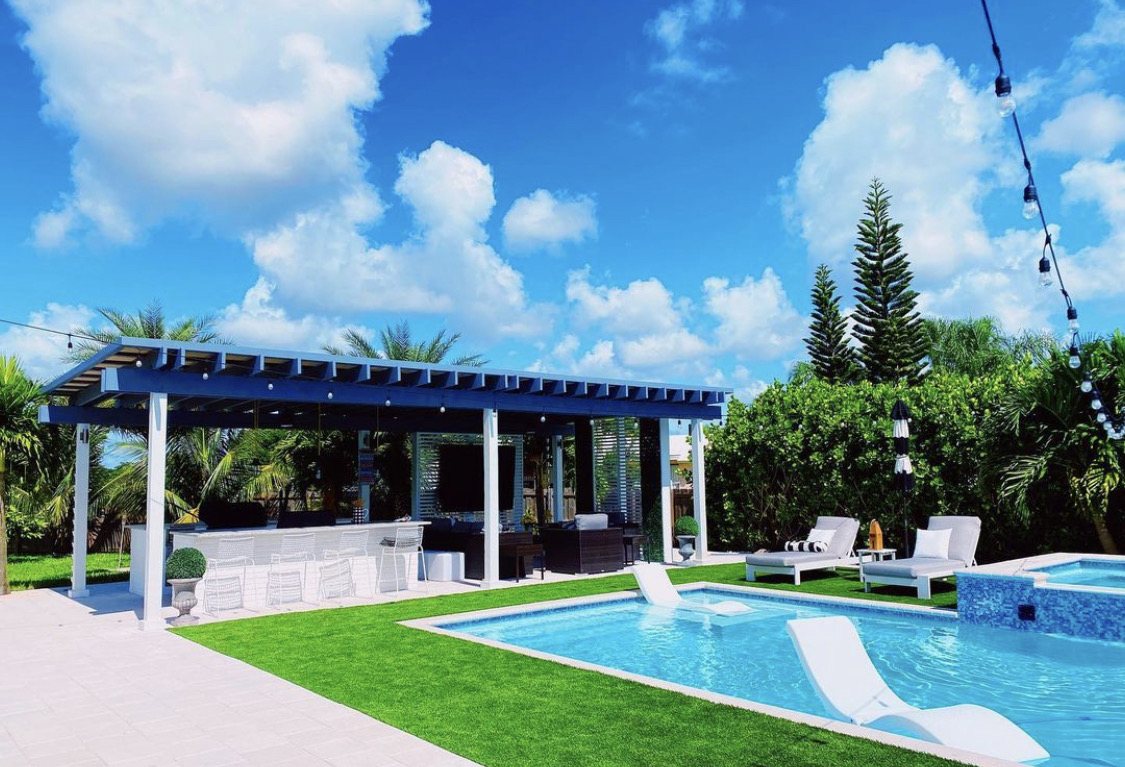 Poolside bar with seating in a custom outdoor kitchen in Miami